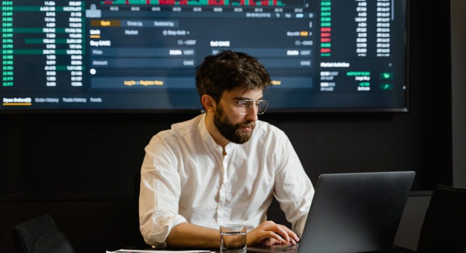 man-in-white-dress-shirt-using-laptop